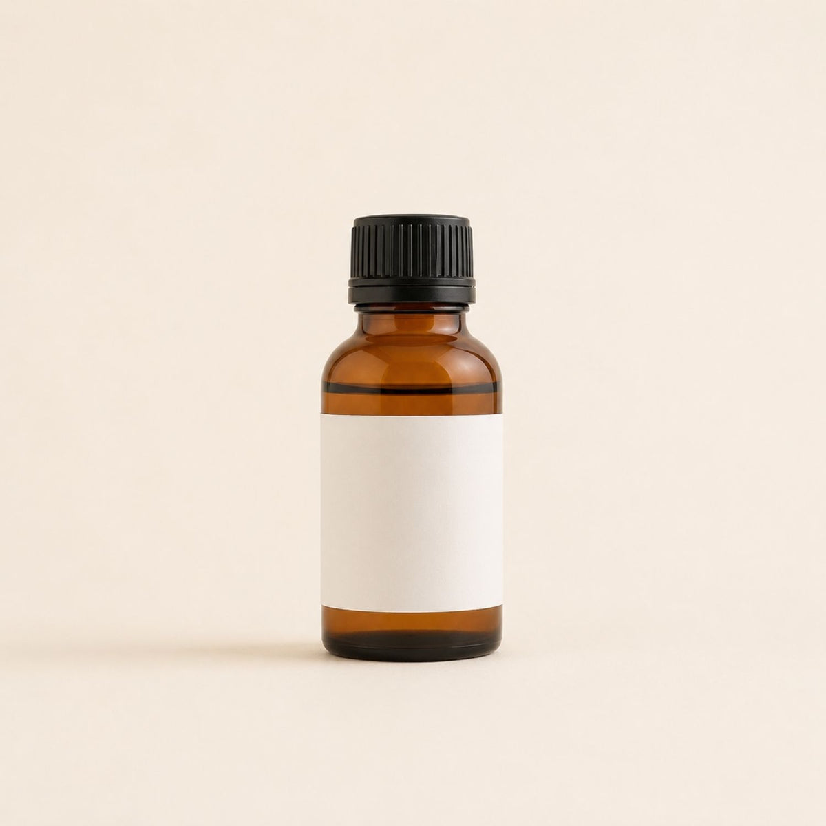 Plain amber fragrance oil bottle on soft ivory background