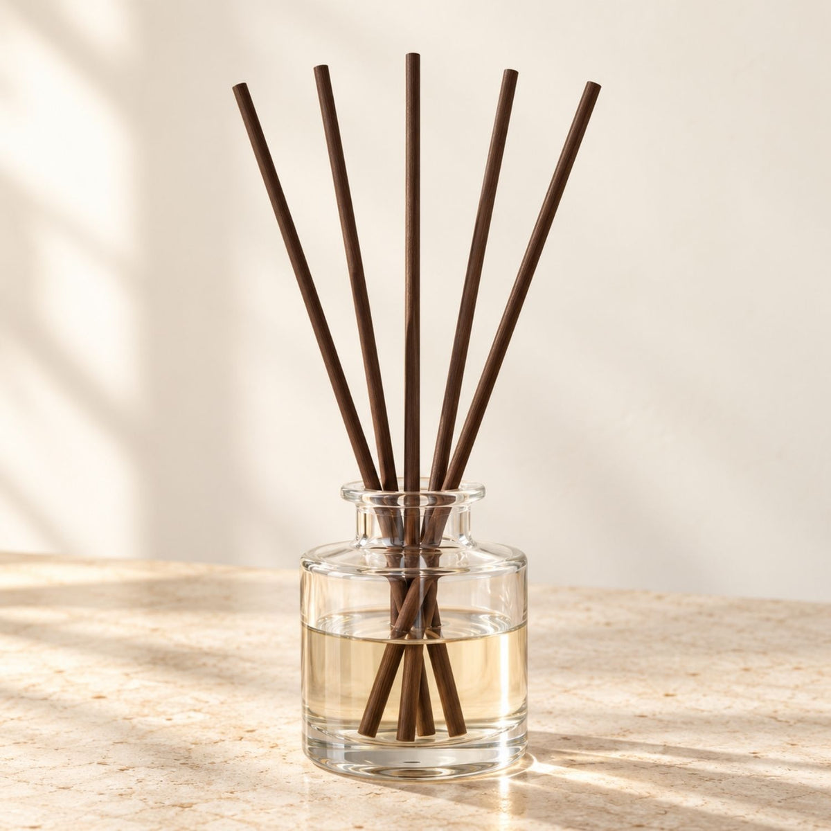 Five fresh Deep Brown Kaze no Shizuku fibre reeds in a clear-glass vessel